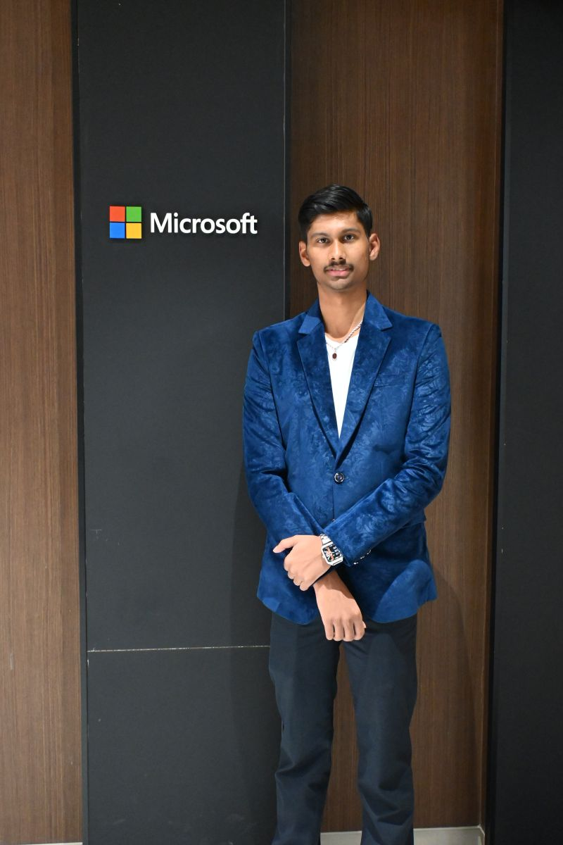 Kartik Bhattacharya, EthicBizz Co-founder and COO, at the Microsoft office in front of the Microsoft logo wall
