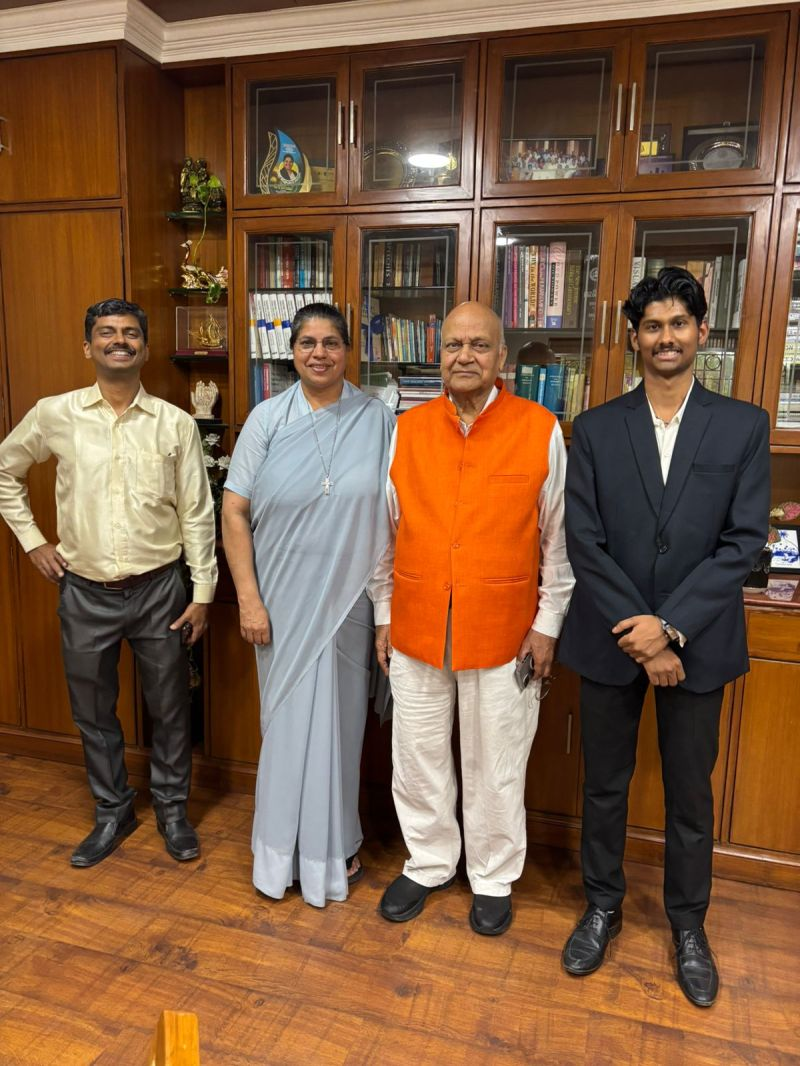 Kartik Bhattacharya with school dignitaries in a library — cyber awareness outreach under EthicBizz
